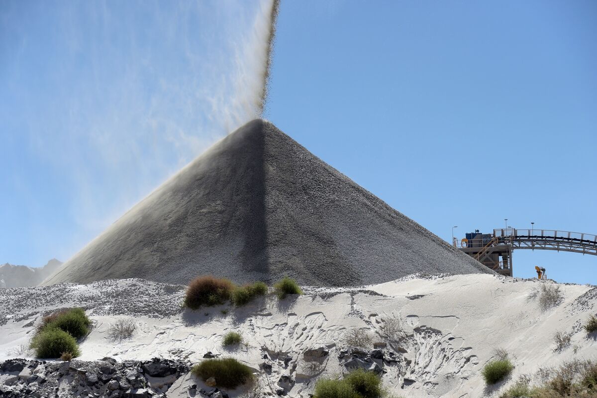 Lithium ore falls onto a stockpile Photographer Carla Gottgens Bloomberg